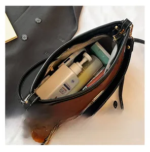 Spacious interior of leopard print suede shoulder bag showing daily essentials