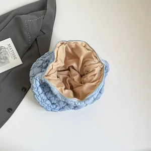 Quilted cloud shoulder bag in light blue puffer material with spacious inner compartment