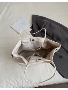 Interior view of tote bag featuring magnetic closure and multiple storage pockets