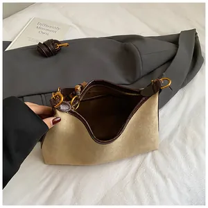 Retro dumpling bag in brown croc leather and beige suede with a gold zipper on white fabric