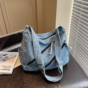 Blue denim crossbody bag with multiple zippers and adjustable strap for casual daily use