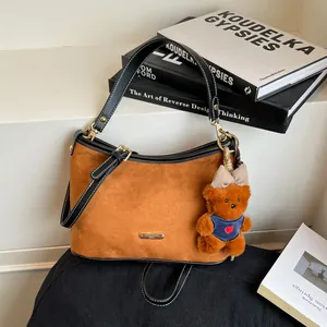 Vintage brown suede moon bag with a cute bear charm and black leather trim for women