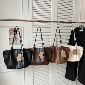 Minimalist faux leather tote bag collection in black, coffee, brown, and cream with charms