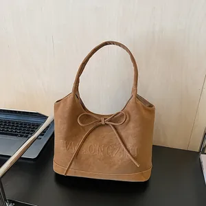 Vintage brown leather tote bag with bow detail and large capacity shoulder design