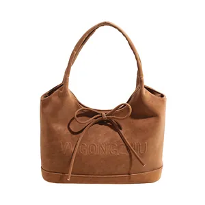 Retro brown oversized tote bag with bow detail and matte leather texture for women