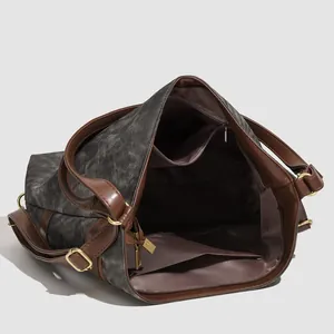 Large dark grey tote bag with brown leather straps and detailed internal pockets