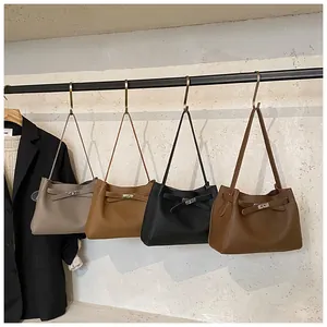 Detail view of stylish tote bags in four colors hanging on a metal display rack