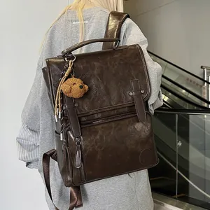Deep brown vintage PU leather backpack for women with flap cover and plush pendant