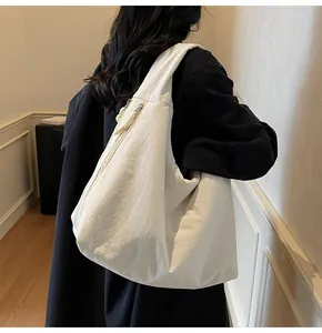 Detailed view of the white nylon tote bag shown from behind to highlight its size and drape