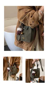 Details der dunkelgrünen Beuteltasche mit Kontrastnähten und Anhänger
