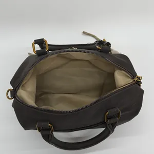 Deep brown Boston handbag with soft leather texture and golden metal hardware