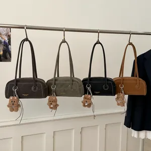 Chic Boston underarm bags in brown and green with contrast stitching and bear charm