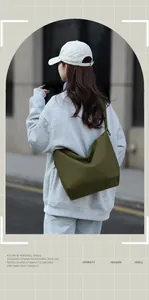 Detail showing the military green nylon tote bag with pleated straps in a street style setting