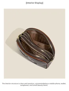 Detailed view of the three zipper compartments and branded lining of the brown crossbody bag