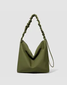 Detail of olive green hobo bag with unique scrunchie pleated shoulder strap and nylon fabric