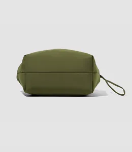 Detail view of the wide flat bottom and tear-resistant fabric of the olive tote bag