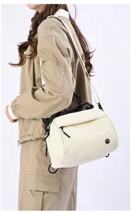 Detail of cream multi-functional crossbody bag with rope handle and matte texture