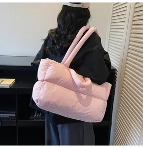Pink quilted puffer tote bag detail featuring soft padded texture and wide shoulder straps