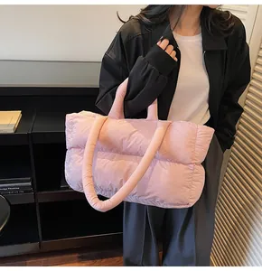 Detail of pink quilted puffer tote bag with spacious capacity for winter daily use