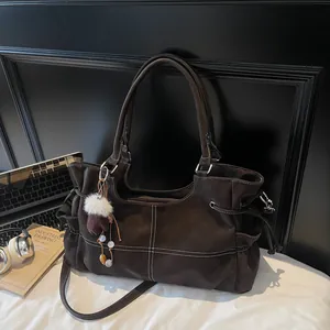 Vintage brown large capacity tote bag with white contrast stitching and tassel charm
