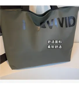 Close-up of olive green tote bag showing VIGOURVIVID print and durable canvas fabric