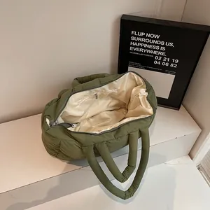 Quilted olive green puffer tote bag with spacious interior and zipper pocket