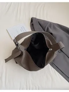Top view of dark brown PU leather tote bag with fabric lining and interior zipper pocket