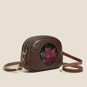 Vintage dark brown Boston bag with red lotus relief and golden dual zipper accents