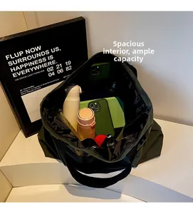 Interior view of spacious green canvas tote bag showing storage for phone and bottle