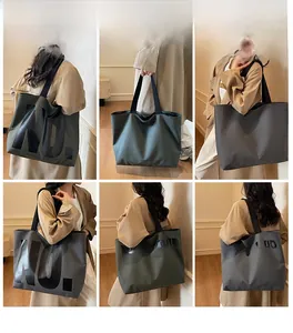 Detail view of large canvas tote bag in dark green and grey with VIGOURVIVID print