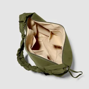 Olive green tote bag with ruched handles and spacious interior pockets for organization