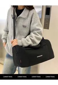 Close-up of black waterproof nylon travel bag featuring brand logo and side zipper pocket