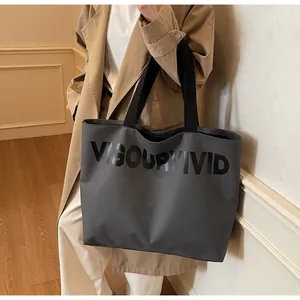 Detail of dark grey tote bag with Vigour Vivid print and black fabric handles