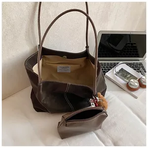 Dark brown leather tote bag with contrast stitching and inner pouch for women commute