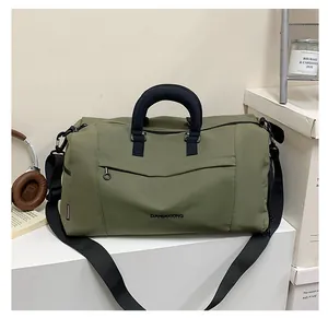 Close-up of army green oxford travel bag with dual handles and adjustable strap details