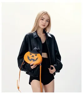 Detail of Halloween pumpkin crossbody bag with wizard hat design worn by model