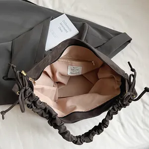 Deep brown large capacity tote bag with chic gathered handle and soft pink lining