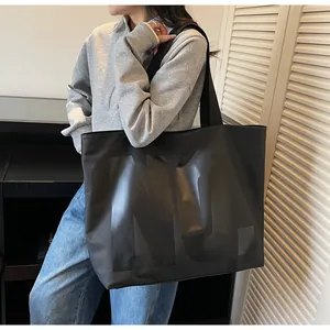Close-up of a large black canvas tote bag with glossy NO. print for daily commuting