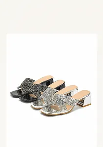 Detail view of sparkly sequin cross-strap slide sandals with mid-high chunky heels