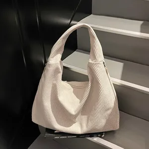 Grand sac hobo minimaliste en velours côtelé beige avec un design texturé à rayures