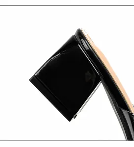 Detail of 6cm square block heel on black patent leather sandals with glossy finish