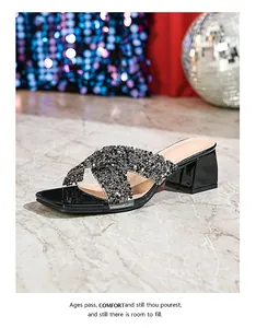 Close-up of women's black platform slide sandals featuring rhinestone-embossed crisscross straps