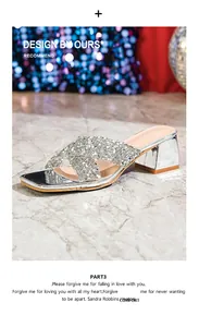 Detailed view of silver rhinestone platform slides with cross straps on a marble surface