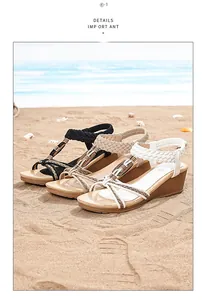 Detailed view of bohemian woven wedge sandals in black, beige, and white on a beach