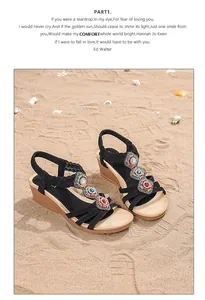 Detail of bohemian wedge sandals with colorful beads and embroidery on a beach setting