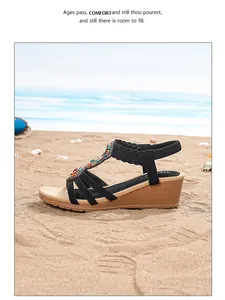 Detail of bohemian wedge sandals featuring colorful gemstones and woven T-strap design