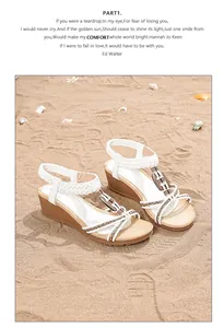 Detail of bohemian wedge sandals with wooden beads on a sunny beach setting