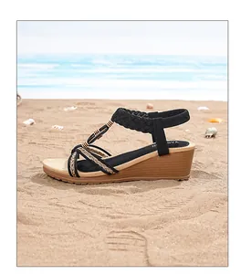 Close-up of Bohemian wedge sandals with woven straps and wood texture on a beach background