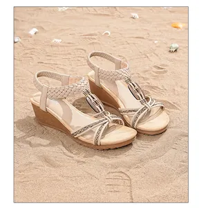 Close-up of bohemian wedge sandals with ethnic wooden beads and woven ankle straps