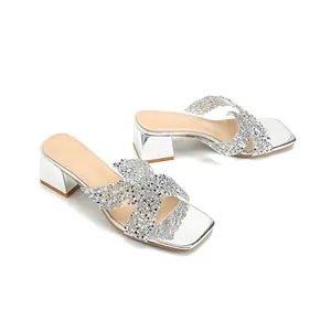 Silver block heel slide sandals with rhinestone cross straps and square toe design